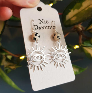 Charity fundraiser design to support the humanitarian crisis in Syria. Shimmering silver earrings with eye of protection design and spotted jasper beads. 'Himaya' ethical hand beaten stainless steel earrings by Nic Danning Jewellery.
