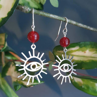 Charity fundraiser design to support the humanitarian crisis in Syria. Shimmering silver earrings with eye of protection design and carnelian beads. 'Himaya' ethical hand beaten stainless steel earrings by Nic Danning Jewellery.