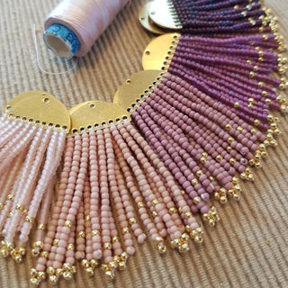 'Hera Oracle' gold plated brass and hand beaded earrings in shades of purple and pink by Nic Danning Jewellery.