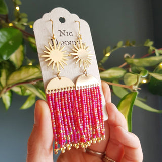 Glowing gold celestial earrings with fine Japanese glass beads in Saturnalia Pink. 'Hera Oracle' gold plated brass and hand beaded earrings by Nic Danning Jewellery.