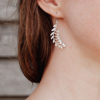 Shimmering silver earrings in Lily of the Valley botanical design. 'Gossamer Hellys' ethical hand beaten stainless steel earrings by Nic Danning Jewellery.