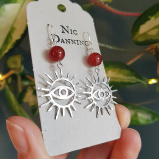 Charity fundraiser design to support the humanitarian crisis in Syria. Shimmering silver earrings with eye of protection design and carnelian beads. 'Himaya' ethical hand beaten stainless steel earrings by Nic Danning Jewellery.