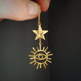 Charity fundraiser design to support the humanitarian crisis in Syria. Glowing gold earrings with eye of protection and star design. 'Himaya' ethical hand beaten brass earrings by Nic Danning Jewellery.