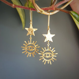 Charity fundraiser design to support the humanitarian crisis in Syria. Glowing gold earrings with eye of protection and star design. 'Himaya' ethical hand beaten brass earrings by Nic Danning Jewellery.