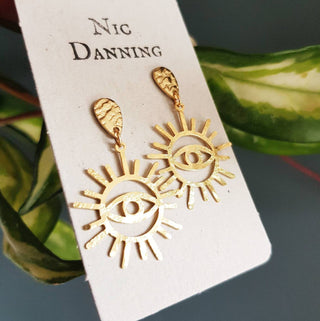 Charity fundraiser design to support the humanitarian crisis in Syria. Glowing gold stud earrings with eye of protection design. 'Himaya' ethical hand beaten brass earrings by Nic Danning Jewellery.