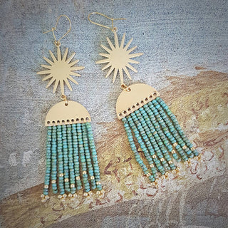Glowing gold celestial earrings with fine Japanese glass and turquoise stone beads in Thalassa. 'Hera Oracle' gold plated brass and hand beaded earrings by Nic Danning Jewellery.