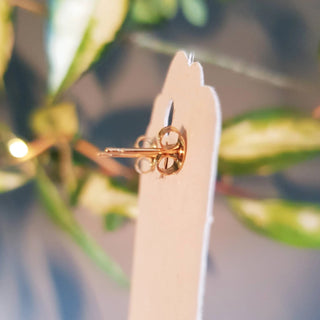 Glowing gold stud earrings in statement heart and sunstar design. 'The Lovers, Miranda' ethical hand beaten brass earrings by Nic Danning Jewellery.