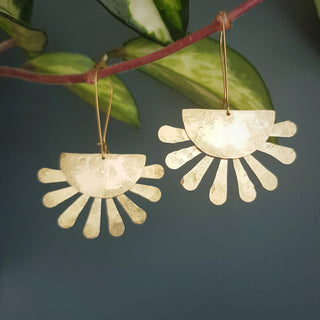 Glowing gold earrings in abstract floral design. 'Tempest Calendula' ethical hand beaten brass earrings by Nic Danning Jewellery.