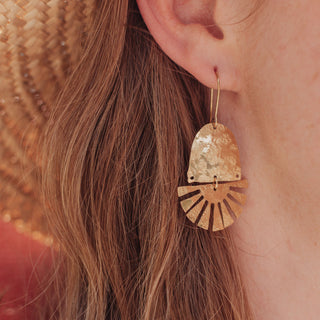 Glowing gold earrings in an abstract sun design. 'Tempest Cardoon' ethical hand beaten brass earrings by Nic Danning Jewellery.