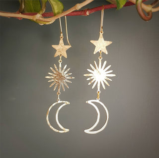 Glowing gold earrings in cascading celestial design. 'Tempest Celestial' ethical hand beaten brass earrings by Nic Danning Jewellery.