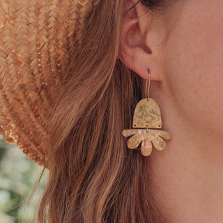 Glowing gold earrings in abstract floral design. 'Tempest Flos' ethical hand beaten brass earrings by Nic Danning Jewellery.