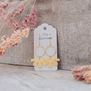 Glowing gold earrings in abstract floral design. 'Tempest Geum' ethical hand beaten brass earrings by Nic Danning Jewellery.