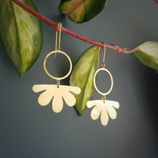 Glowing gold earrings in abstract floral design. 'Tempest Geum' ethical hand beaten brass earrings by Nic Danning Jewellery.