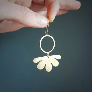 Glowing gold earrings in abstract floral design. 'Tempest Geum' ethical hand beaten brass earrings by Nic Danning Jewellery.