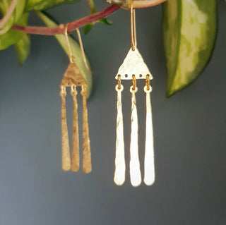 Glowing gold earrings in abstract geometric design. 'Tempest Imbrem' ethical hand beaten brass earrings by Nic Danning Jewellery.