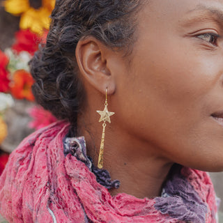 Glowing gold drop earrings in celestial design. 'Tempest Maris' ethical hand beaten brass earrings by Nic Danning Jewellery.
