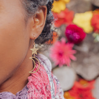 Glowing gold earrings in cascading celestial design. 'Tempest Noctis' ethical hand beaten brass earrings by Nic Danning Jewellery.