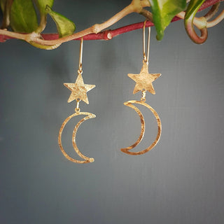 Glowing gold earrings in cascading celestial design. 'Tempest Noctis' ethical hand beaten brass earrings by Nic Danning Jewellery.