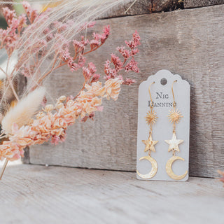 Glowing gold earrings in cascading celestial design. 'Tempest Twilight' ethical hand beaten brass earrings by Nic Danning Jewellery.