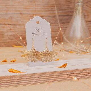 Glowing gold earrings in botanical ginkgo leaf design. 'Gossamer Ginkgo' ethical hand beaten brass earrings by Nic Danning Jewellery.