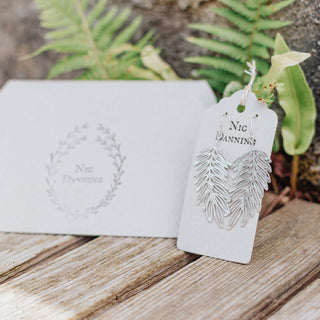 Shimmering silver earrings in botanical cutout leaf design. 'Gossamer Hebe' ethical hand beaten stainless steel earrings by Nic Danning Jewellery.