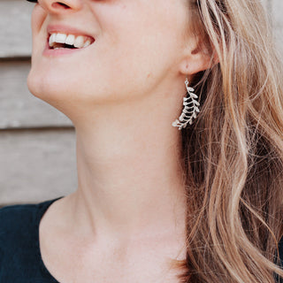 Shimmering silver earrings in Lily of the Valley botanical design. 'Gossamer Hellys' ethical hand beaten stainless steel earrings by Nic Danning Jewellery.