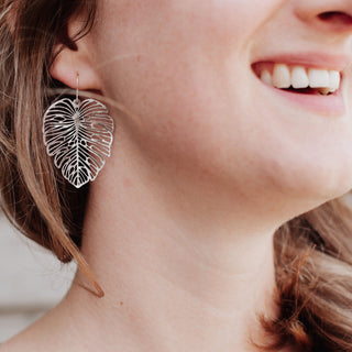 Statement monstera leaf design, shimmering silver earrings. 'Tempest Monsoon' ethical hand beaten stainless steel earrings by Nic Danning Jewellery.