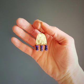 Glowing gold earrings with semi precious lapis lazuli beadwork. 'Titans Olympus' ethical hand beaten brass earrings by Nic Danning Jewellery.