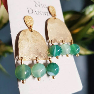 Glowing gold earrings with semi precious agate beadwork. 'Titans Themis' ethical hand beaten brass earrings by Nic Danning Jewellery.