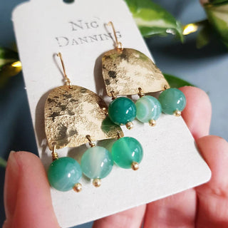 Glowing gold earrings with semi precious agate beadwork. 'Titans Themis' ethical hand beaten brass earrings by Nic Danning Jewellery.