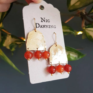 Glowing gold earrings with aqua coloured semi precious carnelian beadwork. 'Titans Hestia' ethical hand beaten brass earrings by Nic Danning Jewellery.