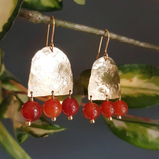 Glowing gold earrings with aqua coloured semi precious carnelian beadwork. 'Titans Hestia' ethical hand beaten brass earrings by Nic Danning Jewellery.