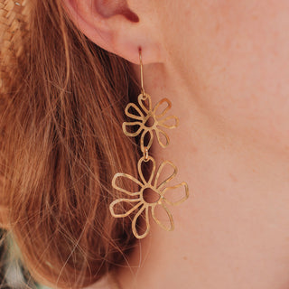 Glowing gold earrings in statement floral design. 'Tempest Garland' ethical hand beaten brass earrings by Nic Danning Jewellery.