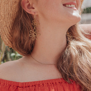 Glowing gold earrings in statement floral design. 'Tempest Garland' ethical hand beaten brass earrings by Nic Danning Jewellery.